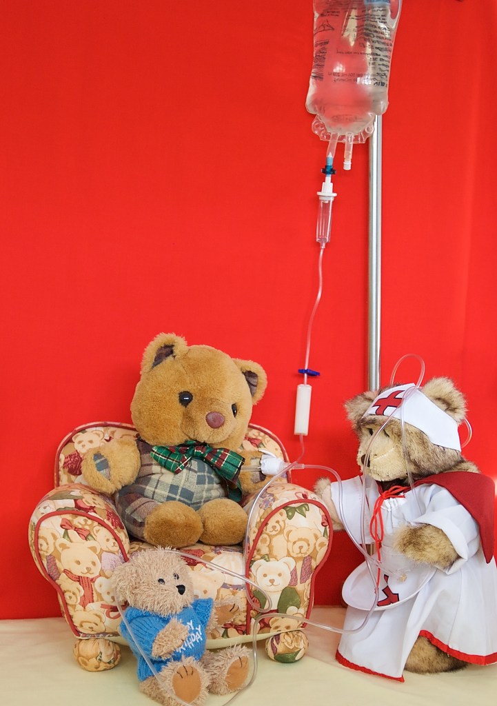 Nurse Bree attaches the drip line to Scotty but Little Teddy tangles her up with the line.