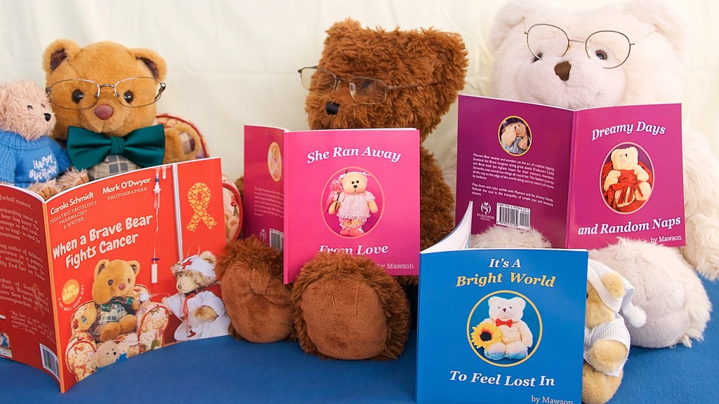 Mawson and friends look over his books and a book they helped to make