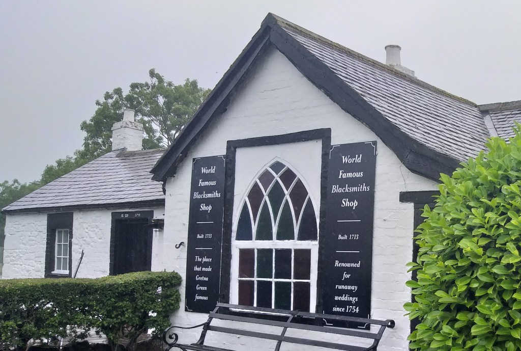 Photo of the Blacksmith's Shop at Gretna Green under a rainy sky